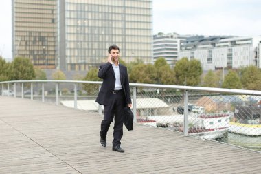 Yürüyüş ve telefonla konuşan Avrupa iş adamı.