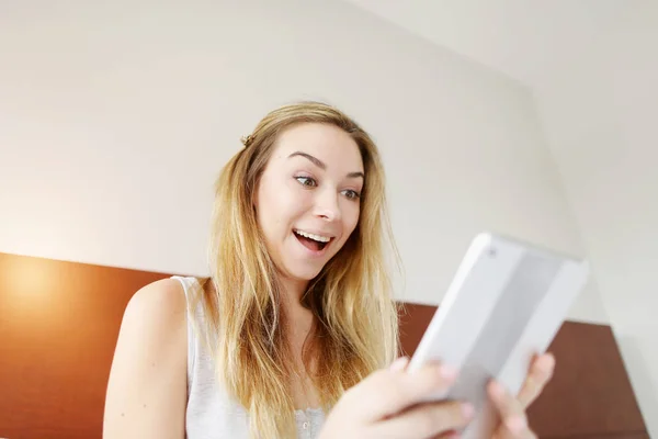 crazy happy young woman working smilling with tablet at white bed