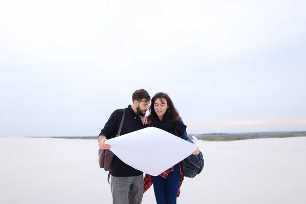 Presenters of travel program married couple viewing map.