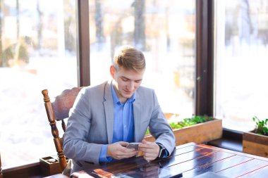 Yanında smartphone tablet yakınındaki kafede chat yapan işadamı.