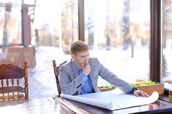 Student of architecture faculty looking at drafting work at cafe