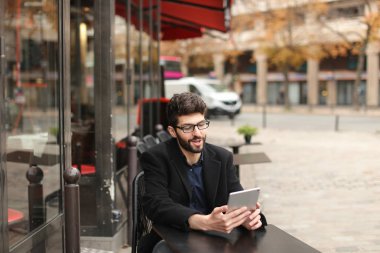 Online poker oyuncusu kafeterya masada tablet kullanma  .