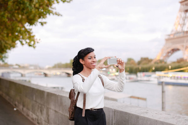 Model walking on street and shooting videos in breaks between ph