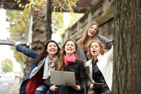 Étudiants européens apprenant avec ordinateur portable et papiers, assis sur être — Photo