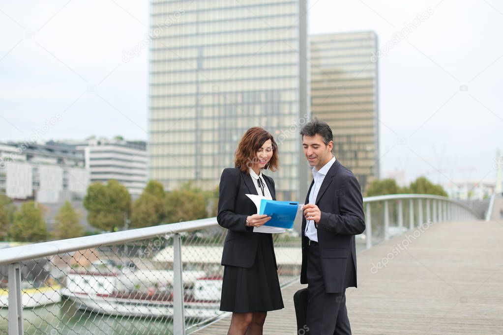 Architect male and contractor female discuss details of contr