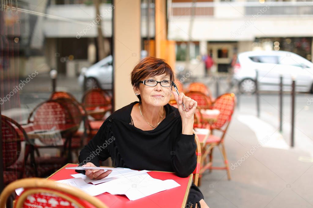 Aged business woman use tablet for writing finance declarat