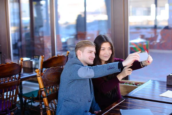 Medical students using smartphone to take selfie at cozy cafe — Stock Photo, Image