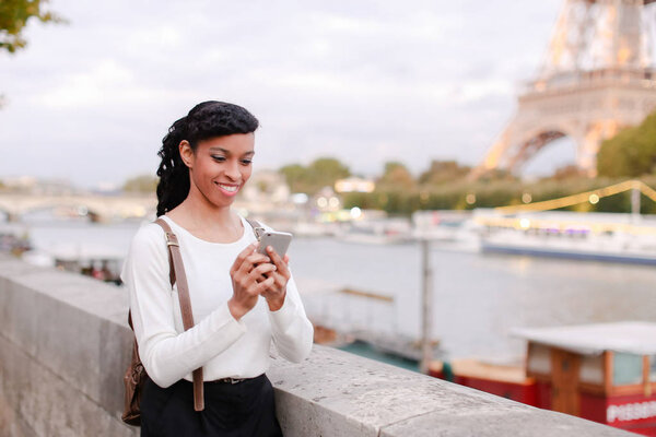 Model walking on street and shooting videos in breaks between ph