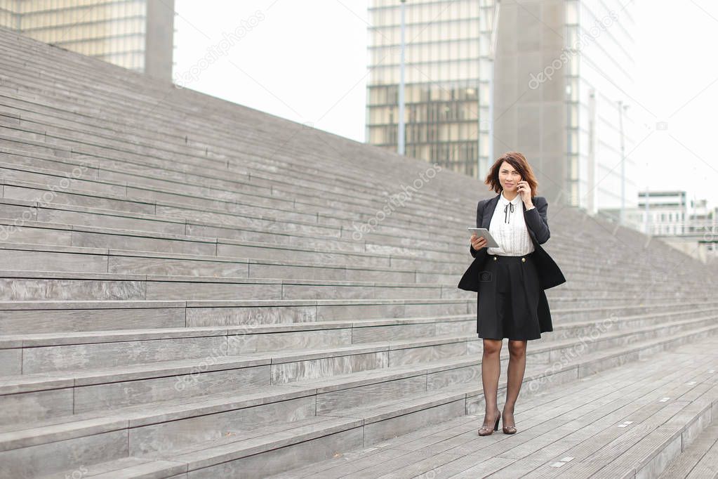      asian appearance business woman walk along stairs speaking 