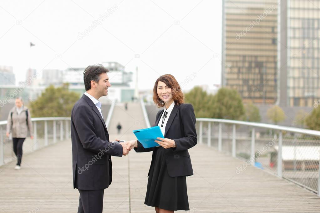      old IT business partners man with smartphone and woman meet