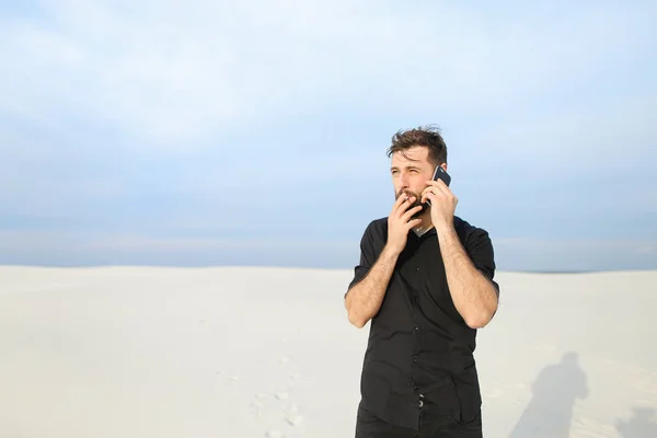 Husband speaking on smartphone with wife walking at seaside sm