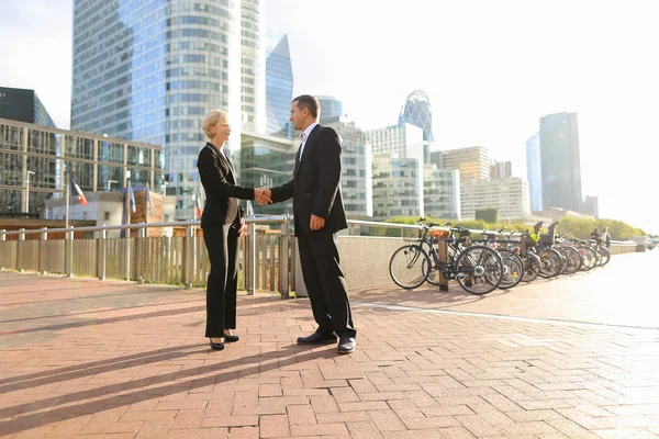 Male boss talking with business employees in La Defense Paris.