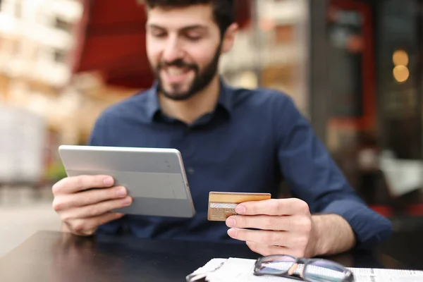 Traveler buying journey tickets with money card and tablet in  .