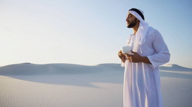 Portre, yakışıklı genç Arap bardaktan içen Şeyh