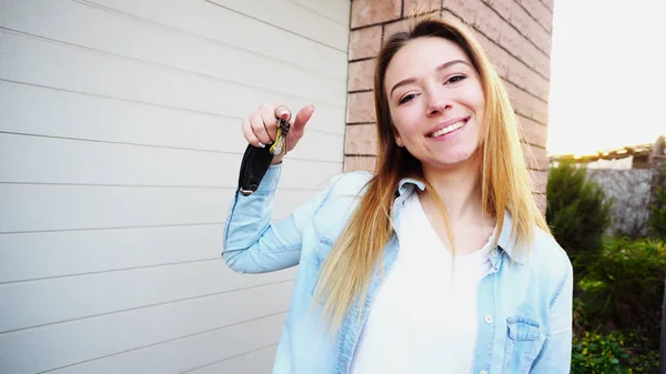 Happy girl standing near garage with car keys. — Stock Photo, Image