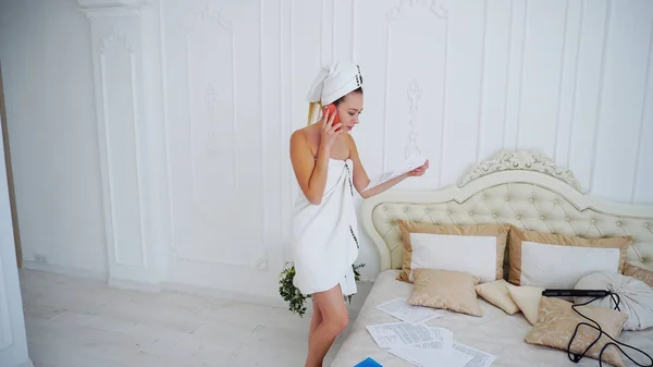 Modern Female Business Woman talk on phone and Reading Work Documentation after shower — Stockfoto