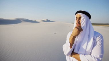 Stately Arabian UAE Sheikh man looks hard into distance and pond clipart