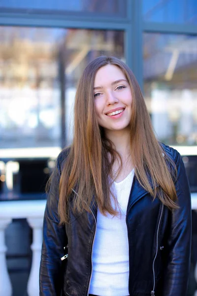 Pretty woman standing near window in city. — Stock Photo, Image