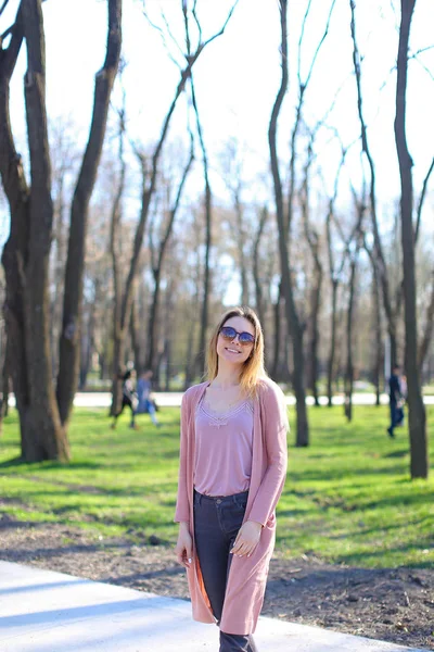 Donna che cammina nel parco e indossa maglione lungo . — Foto Stock