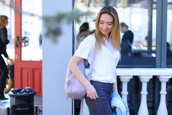 Bella donna in piedi vicino alla finestra con zaino rosa chiaro . — Foto Stock