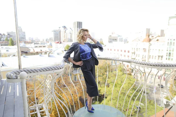 Modelo de foto femenina de pie en el balcón con fondo de paisaje urbano . — Foto de Stock