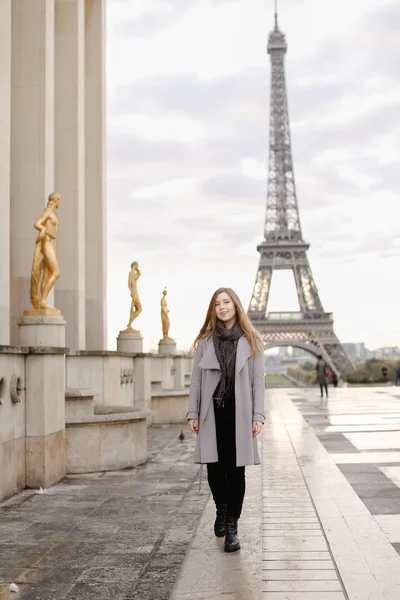 Young woman standing on Trocadero square near gilded statues and Eiffel Tower. — Stock Photo, Image