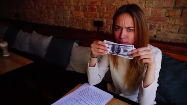 Jocund dziewczyna bawi się pieniądze w kawiarni i uśmiechając się. — Wideo stockowe