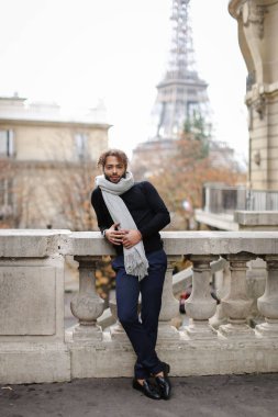 Afro Amerikan yakışıklı genç adam ile Paris'te Eyfel Kulesi arka plan beton korkuluk yakınındaki ayakta.