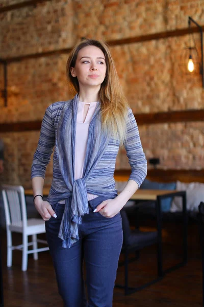 Girl stay near table in cafe.