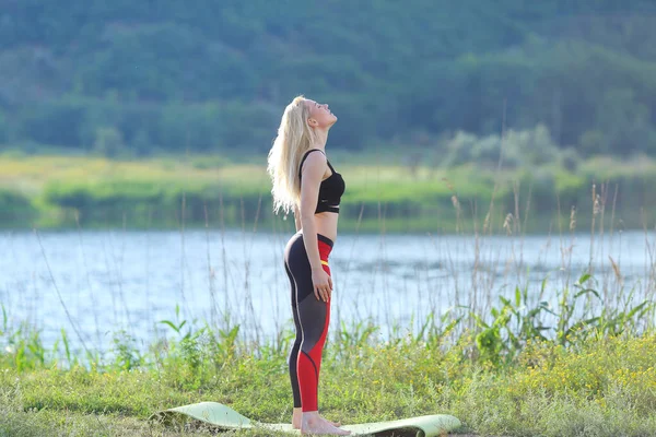 Young beautiful woman squats shows result press on stomach workout training wearing top