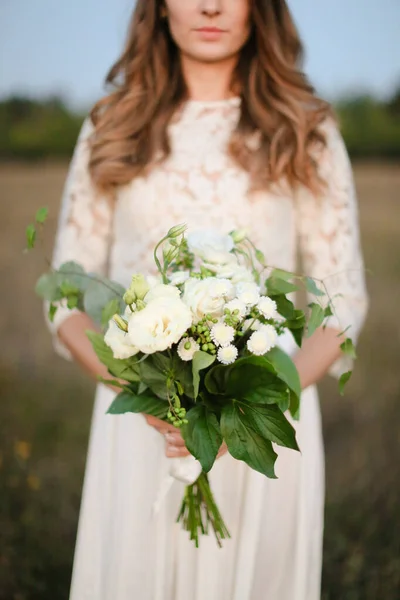 Bride with white bouquet background in steppe background. — Stock Photo, Image