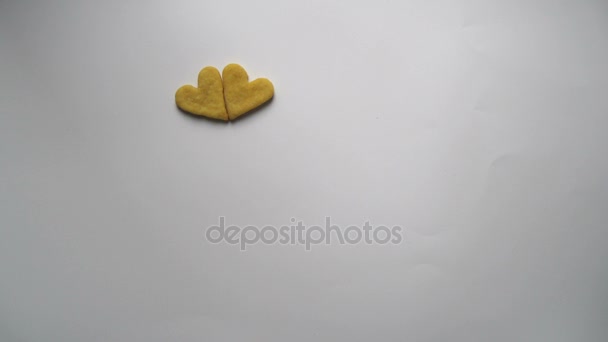 Heart shaped cookies pattern appears on a white background stop motion animation — Stock Video