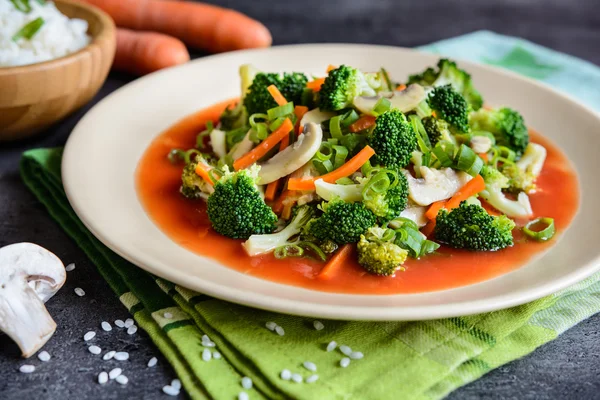 Steamed broccoli with mushroom, carrot and onion, served with tomato sauce and rice