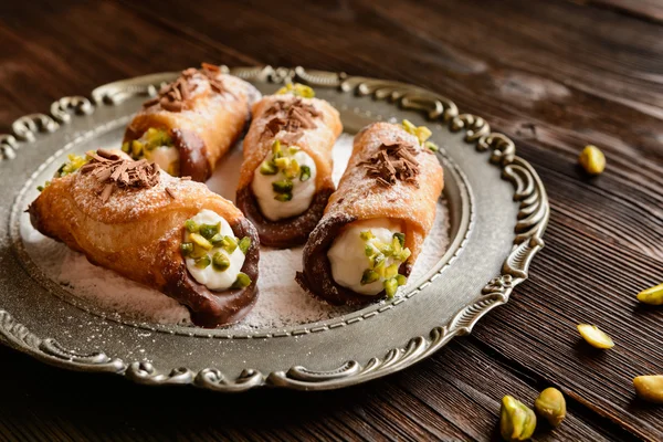 Traditional Sicilian cannoli stuffed with ricotta and pistachios