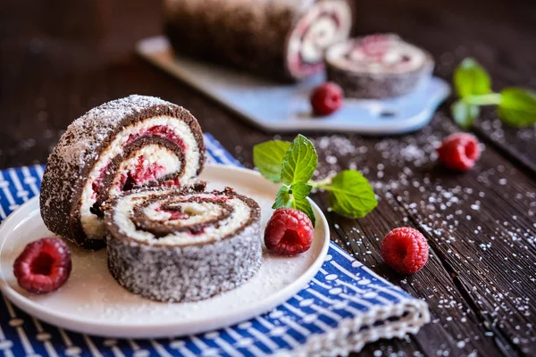 Chocolate roll cake with coconut and raspberry filling — Stock Photo, Image