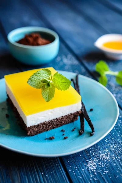 Chocolate cake bars with mascarpone layer and orange jelly topping — Stock Photo, Image