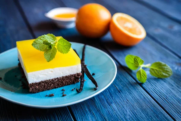 Chocolate cake bars with mascarpone layer and orange jelly topping — Stock Photo, Image