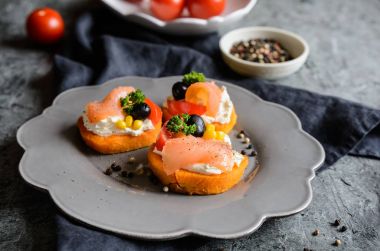 Tatlı patates dilimleri krem peynir ile tepesinde, Mısır, zeytin ve somon füme