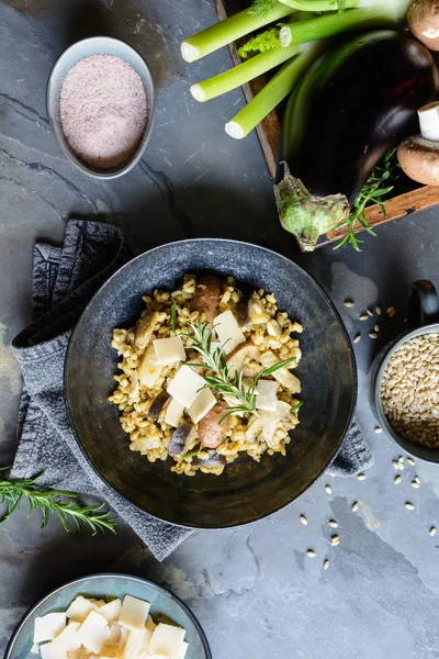 Вегетарианское ризотто с жареными грибами, фенхелем и ломтиками сыра пармезан — стоковое фото