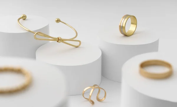 Nowoczesna bransoletka w kształcie łuku oraz kolekcja pierścieni na białej platformie cylindrów — Zdjęcie stockowe