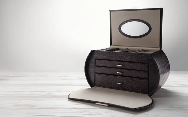 Leather brown jewelry box on white wooden table. Leather accessories box with drawers on white desk. — 스톡 사진