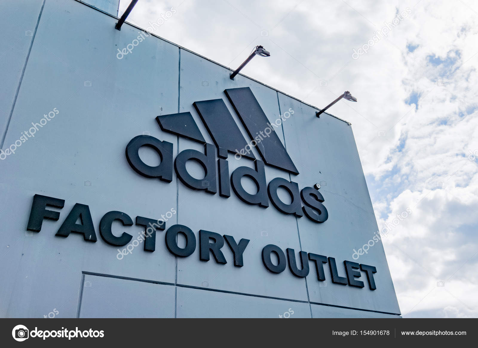 Adidas Factory outlet. Sign aganist the 