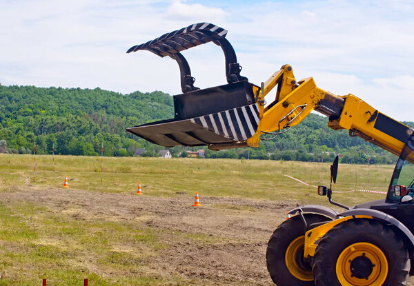 Bucket tractor yellow. Side view.