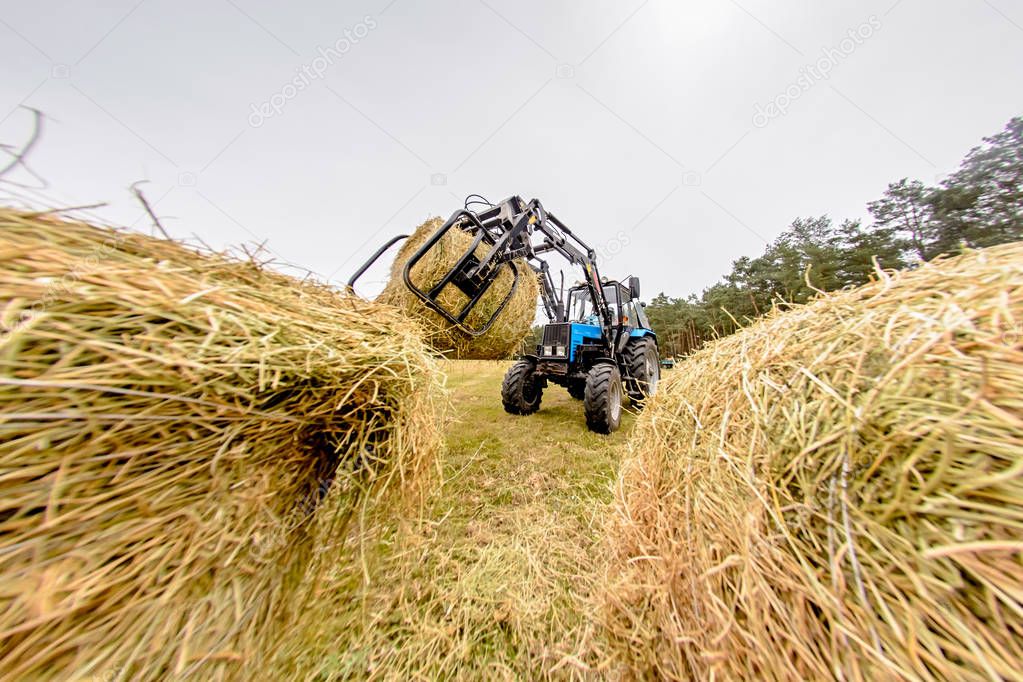 tractor hay stacks in the field. Toning