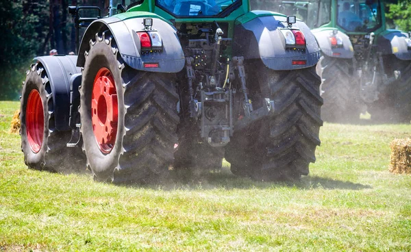 Potężny traktor koła przejść od podstaw pyłu. Efekt małych ruchu — Zdjęcie stockowe