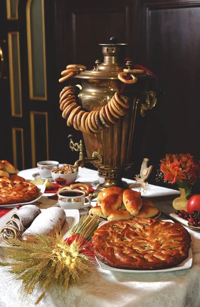 Table for tea. A samovar with pies. Royalty Free Stock Images