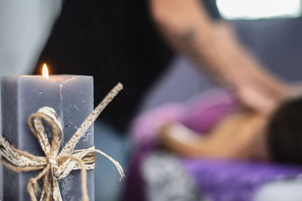 Aromo candle burns in the massage parlor. Focus on the candle. Shallow depth of field