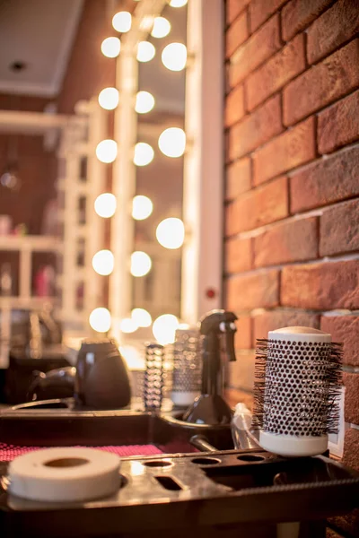 Rund hårborste och andra verktyg i skönhetssalongen. Fokusera på kammen. Grunt skärpedjup — Stockfoto