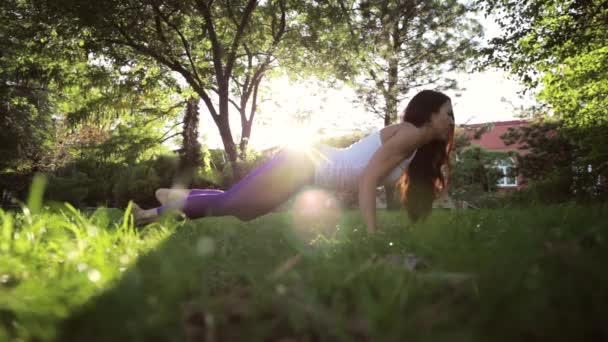 Yoga and pilates exercises on the lawn at sunny morning. — Stock Video