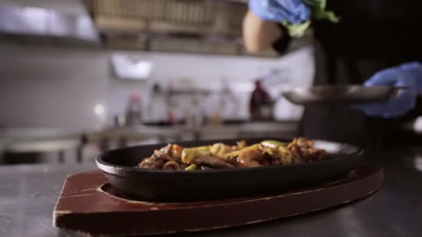Chef adding herbs to pan with vegetables and meat on wooden stand. — Stock Footage Chef adding herbs to pan with vegetables and meat on wooden stand. Stock Video
